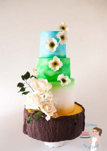 A summery Tree Stump inspired wedding that showcases the blue clouds and green pastures, the white of purity; all perched on a tree stump cake. A unique but gorgeous creation by Veena Azmanov of Veena's Art of Cakes