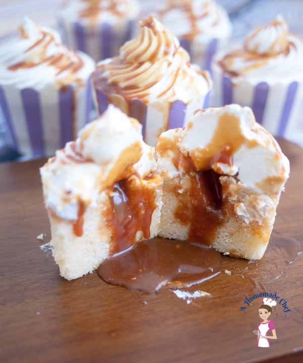 This Caramel Cupcakes recipes is simply the most decadent you can get, with a light and fluffy Vanilla Sponge on the inside; filled with soft sweet caramel, topped with delicious Swiss Meringue Buttercream and then drizzled with some more caramel again by food blog A Homemade Chef. This Caramel Cupcakes recipes is simply the most decadent you can get, with a light and fluffy Vanilla Sponge on the inside; filled with soft sweet caramel, topped with delicious Swiss Meringue Buttercream and then drizzled with some more caramel again by food blog A Homemade Chef.