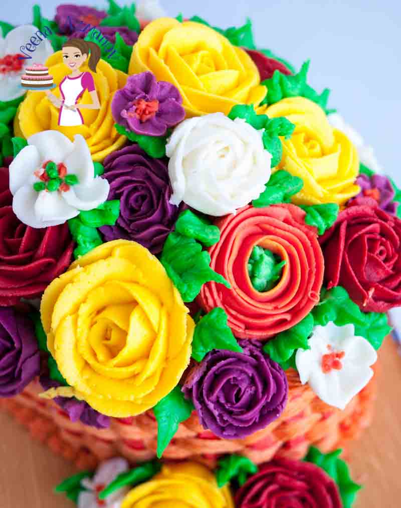 A close up of a cake decorated like a basket of flowers.