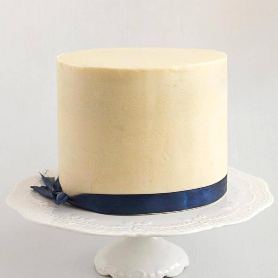 A cake frosted with white chocolate ganache.