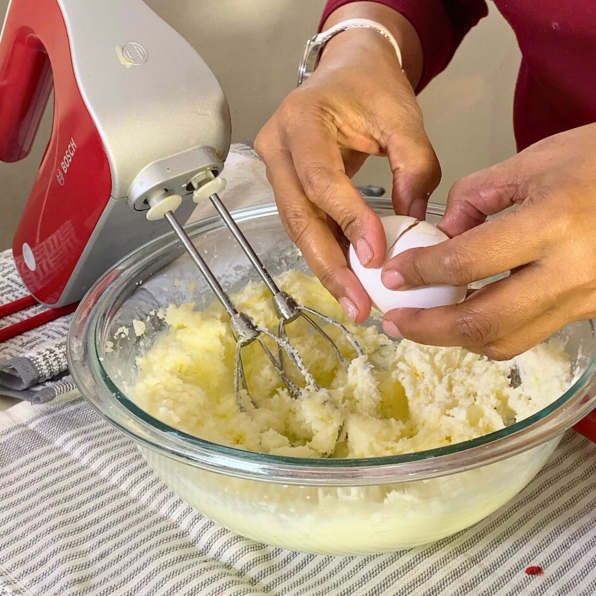 Progress pictures, adding eggs one by one to the cake batter.