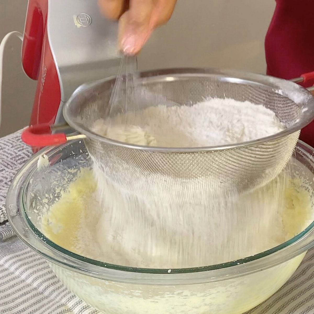 Progress pictures adding dry ingredients to the cake batter.