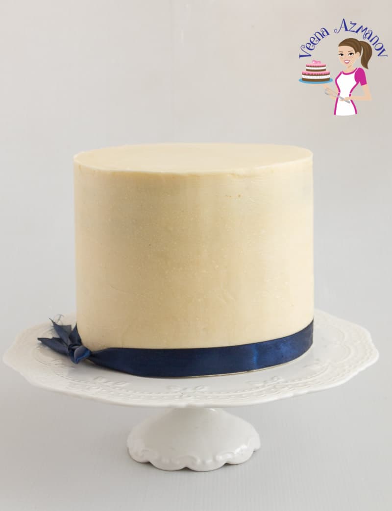 A cake covered with white chocolate ganache.