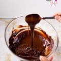 A person melting chocolate in a bowl.