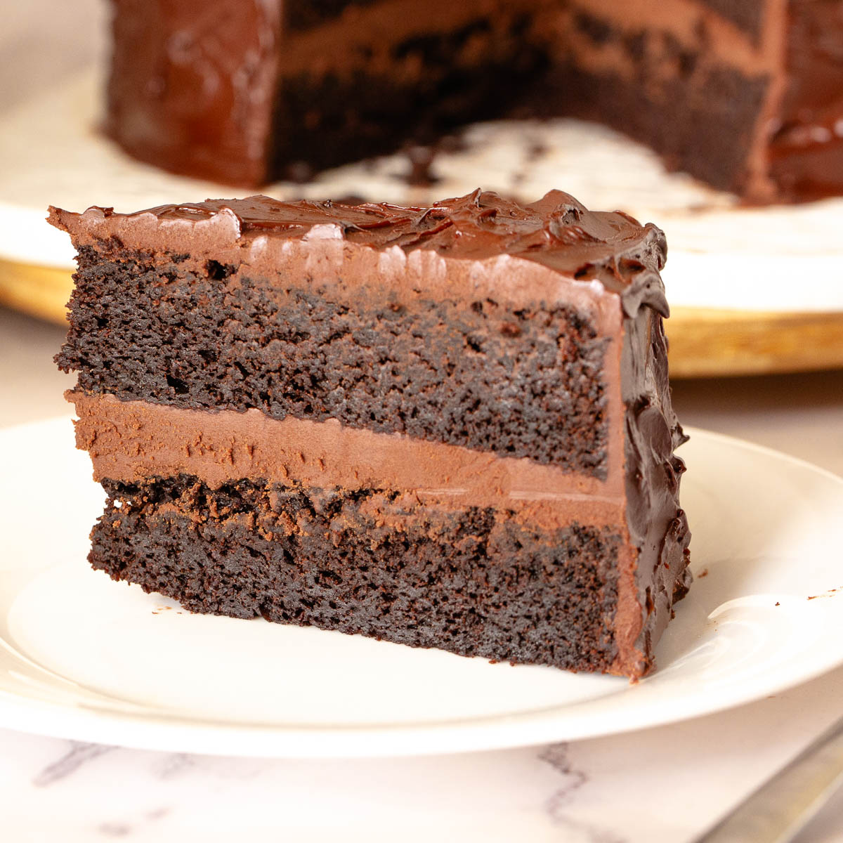 A slice of chocolate mud cake on the table.