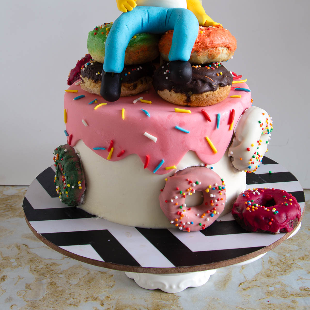 Homer Simpson cake decorated with a pile of donuts and a handmade fondant topper