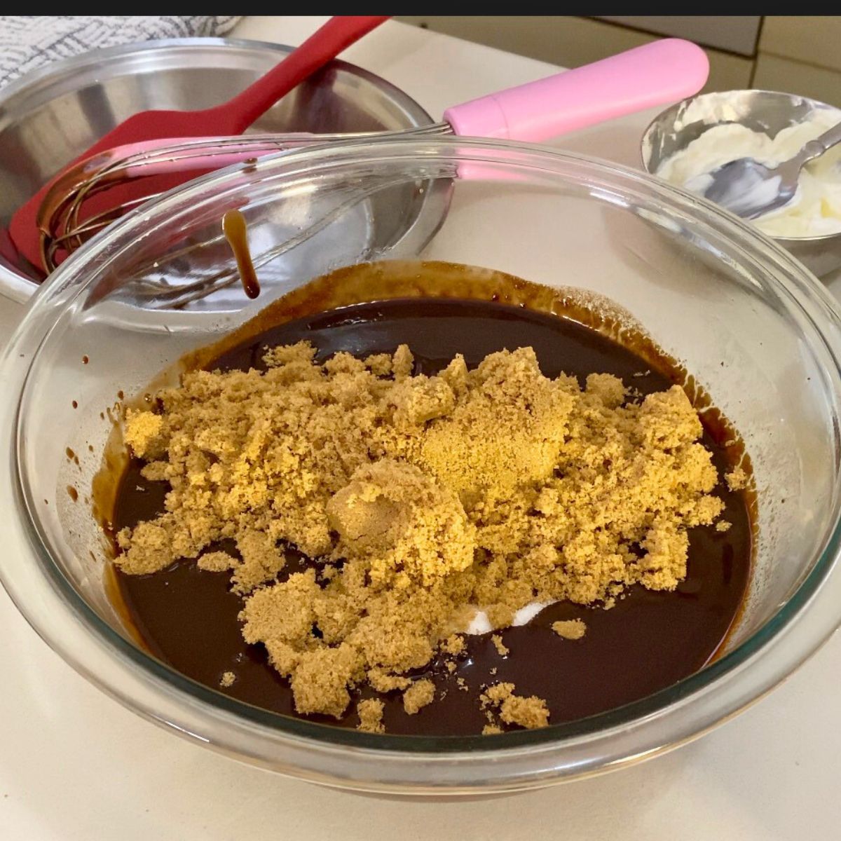 Progress pictures adding sugars to melted chocolate and butter.