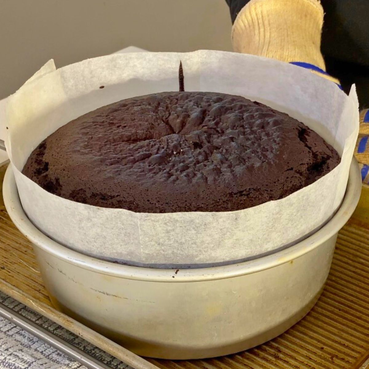 Baked chocolate mud cake in a cake pan progress pictures.