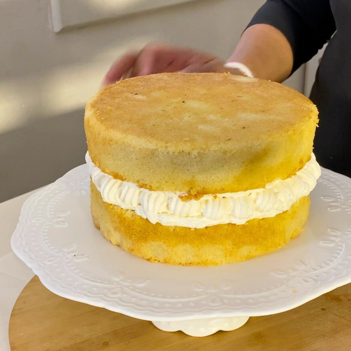 Two layers of Victoria Sponge Cake on Cake Stand.