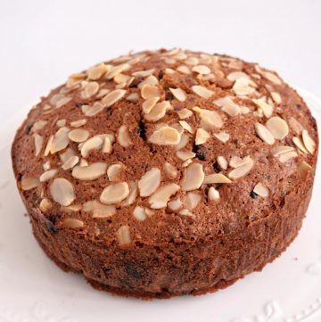 A fruit cake topped with almonds.