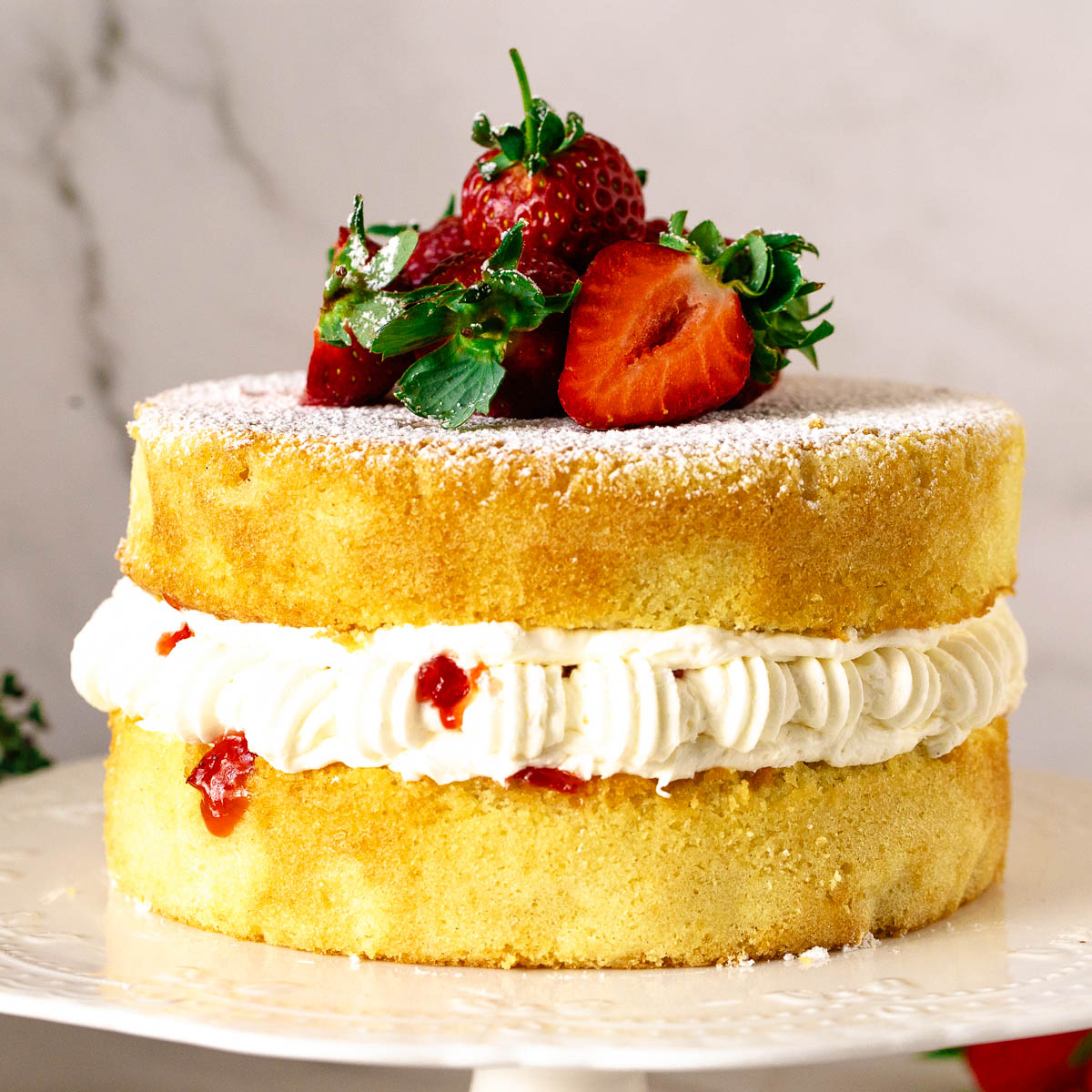 A stacked victoria sponge with jam.