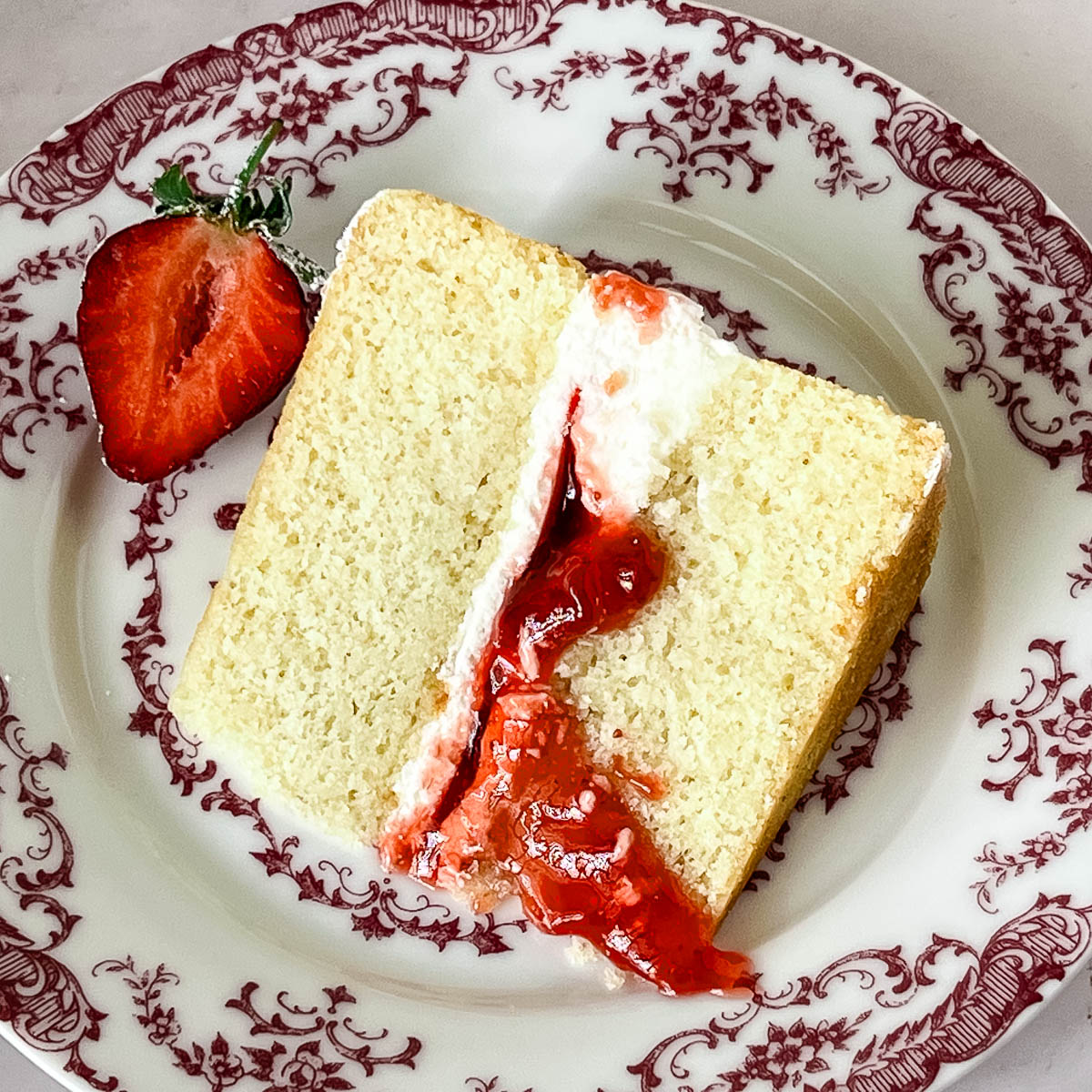 A slice of Victoria Sponge Cake on the plate.