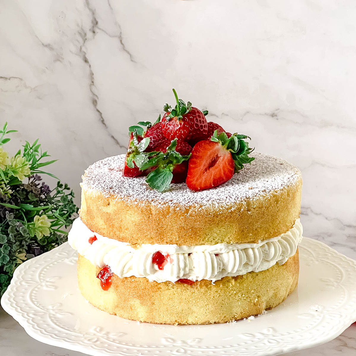 Frosted Victoria sponge cake with Jam and buttercream.