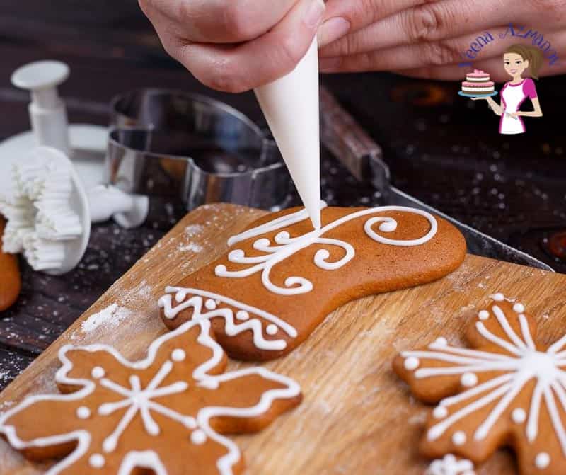 Decorating gingerbread cookies with icing.