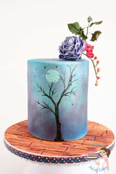 A cake decorated in a purple sky theme.