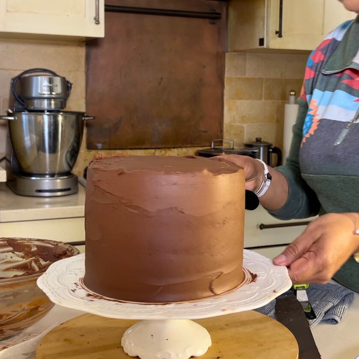 Frosting a devils food cake with ganache.