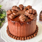 Rich and moist Devil’s Food cake frosted with smooth chocolate ganache for an elegant chocolate dessert.