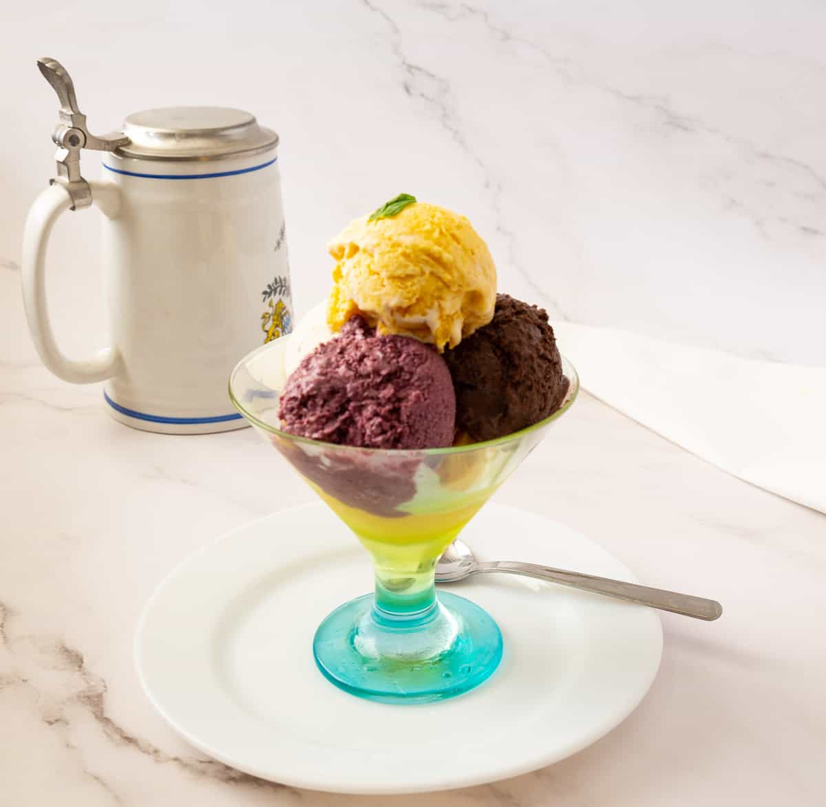 Ice cream scoops in a fancy glass bowl.
