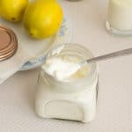 a mason jar with sour cream and spoon