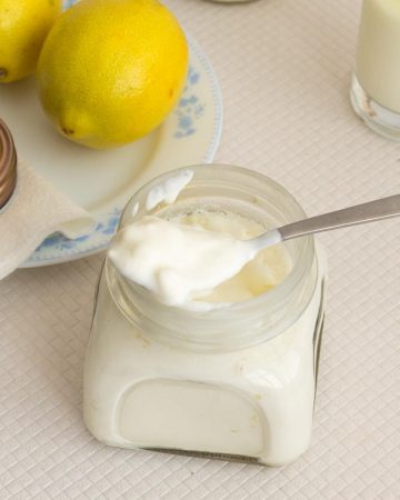 a mason jar with sour cream and spoon