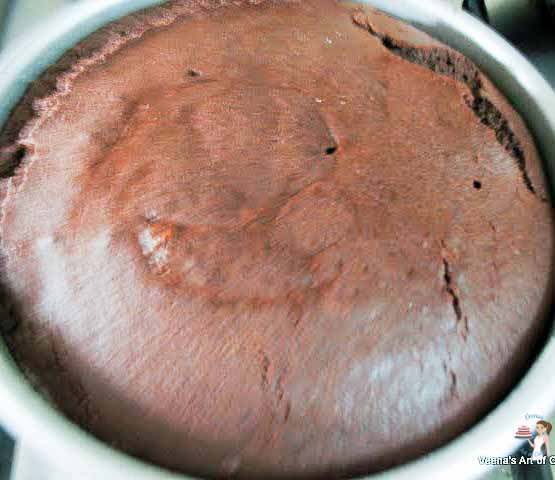 A baked sugar-free chocolate cake in a baking pan.