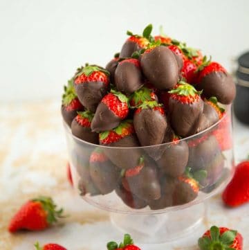 A bowl with chocolate dipped strawberries.
