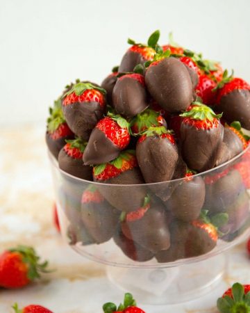 A bowl with chocolate dipped strawberries.