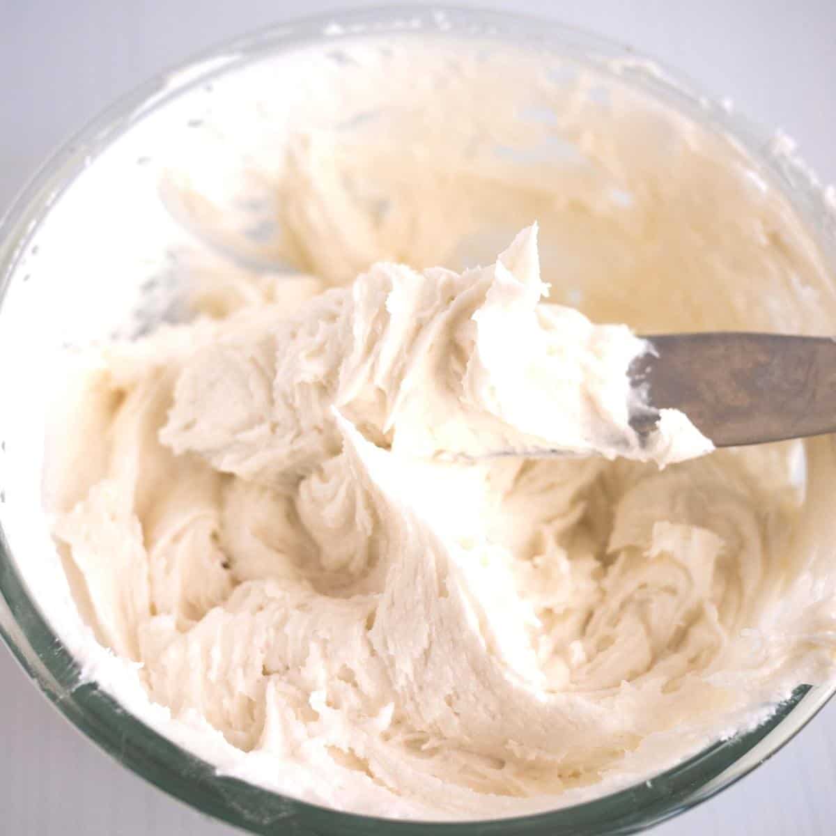 A bowl with cream cheese frosting