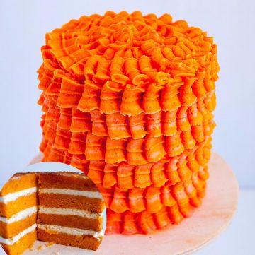 A frosted layer cake with orange Swiss meringue buttercream.