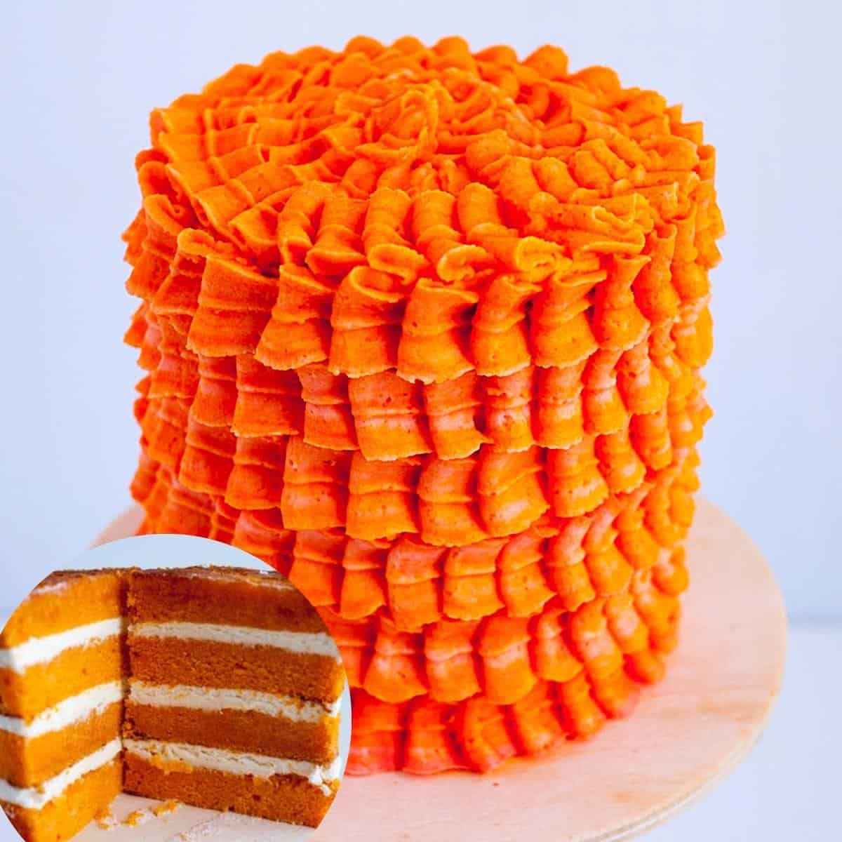 A frosted layer cake with orange Swiss meringue buttercream.