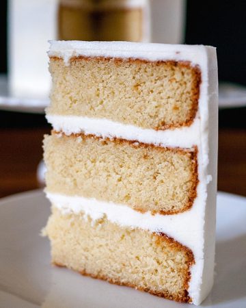 A slice of vanilla cake on a plate.