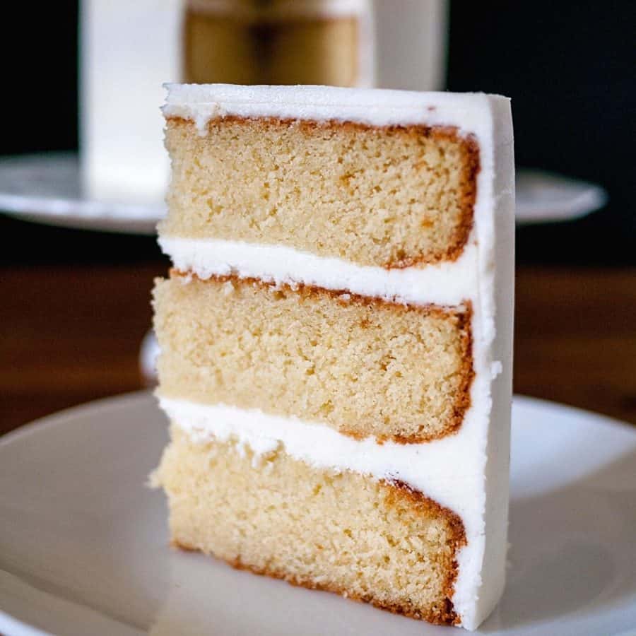 A slice of vanilla cake on a plate.