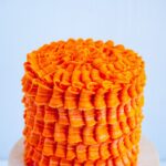 Pinterest image for an Orange Birthday Cake with Orange Swiss Meringue Buttercream.