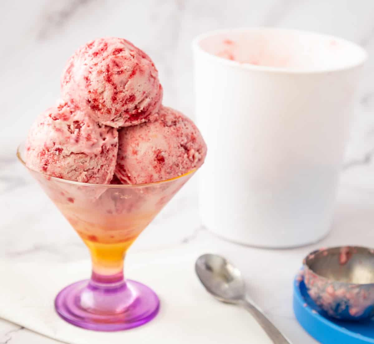 Raspberry ice cream in an ice cream bowl.