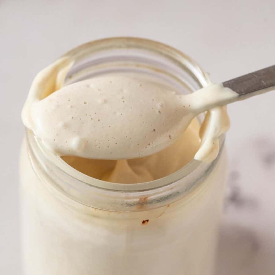 Tahini sauce in a mason jar.
