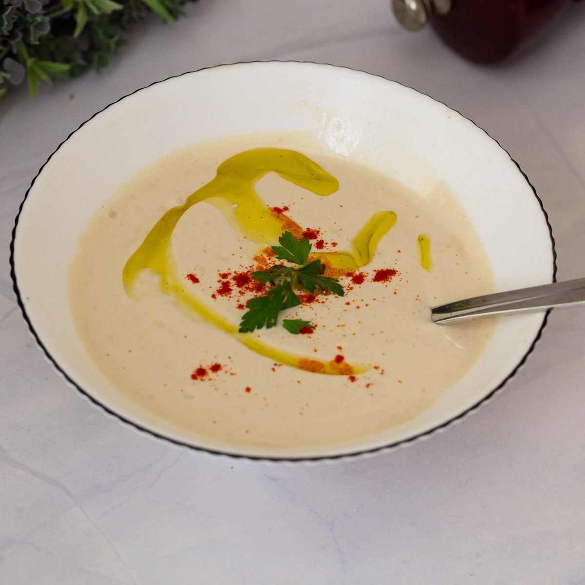 A bowl with tahini sauce.