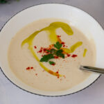 A bowl with freshly made sauce with tahini paste.