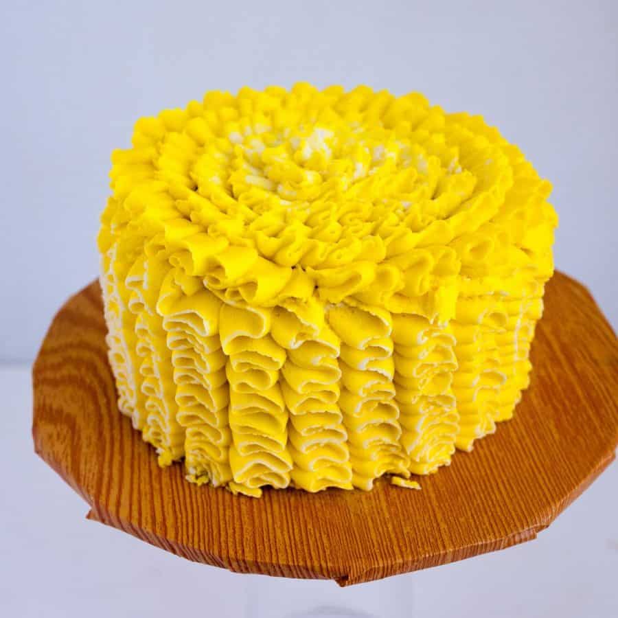 Frosted lemon cake on the cake stand.