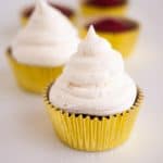 A cupcake with cream cheese frosting.