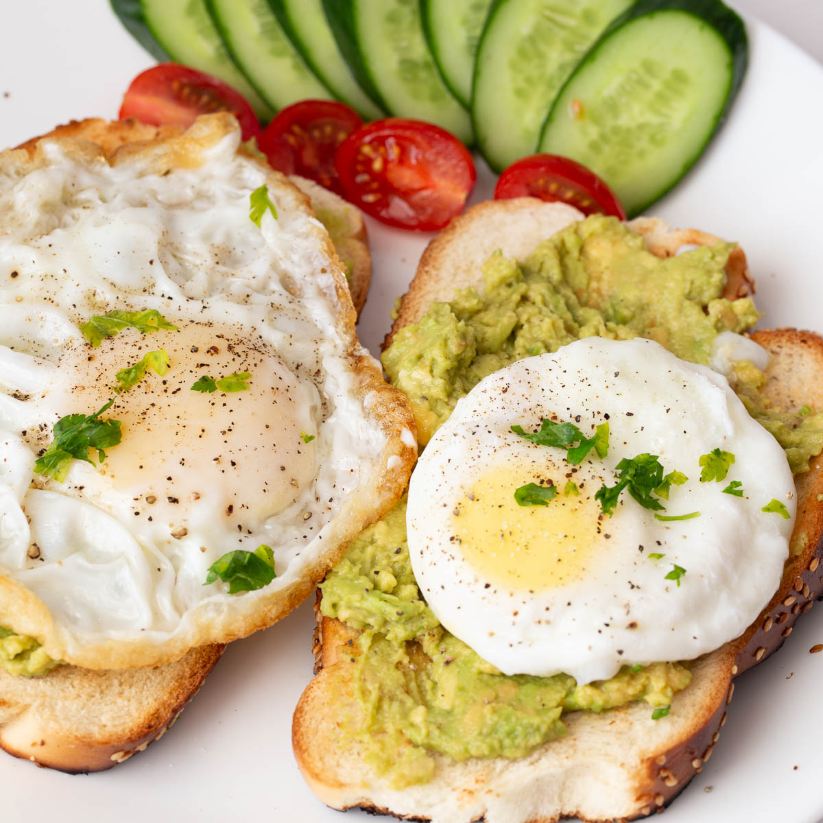 A plate with avocado and egg sandwich.