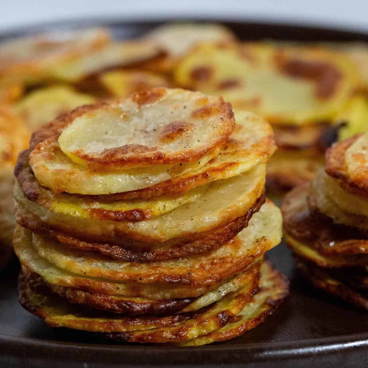 Stack of potato chips on a plate. 