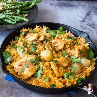 A skillet with Chicken and rice.