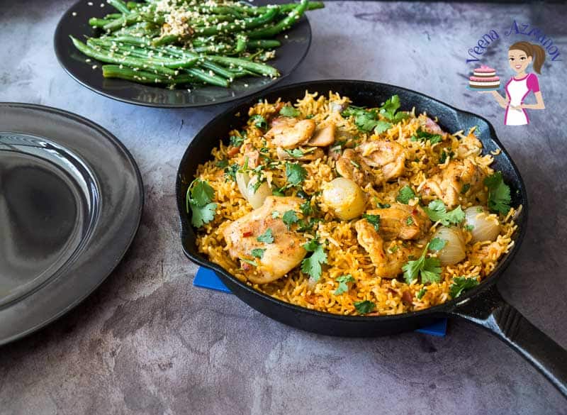 A skillet with chicken with rice.