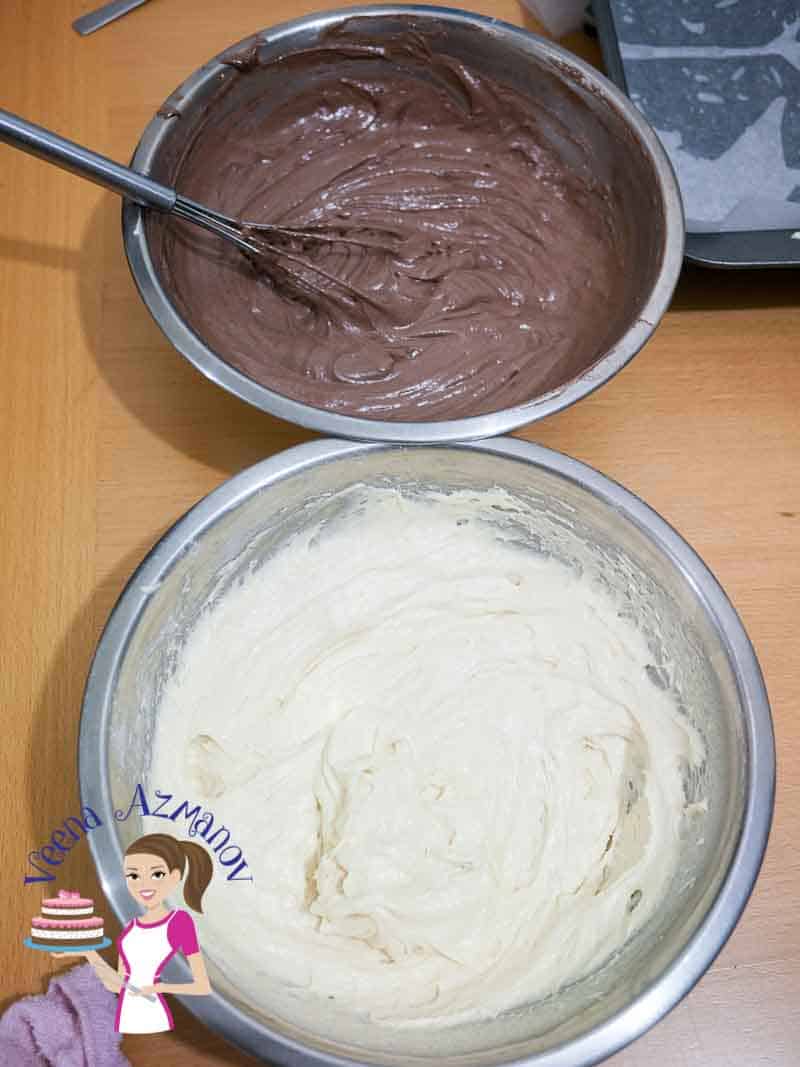 A bowl with vanilla cake batter and a bowl with chocolate cake batter.