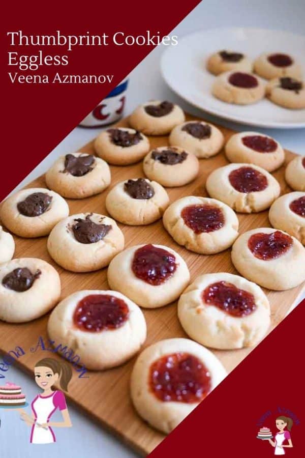 A tray of thumbprint cookies with jams and chocolates.