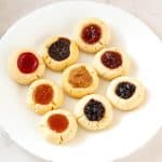 A plate with eggless thumbprint cookies.