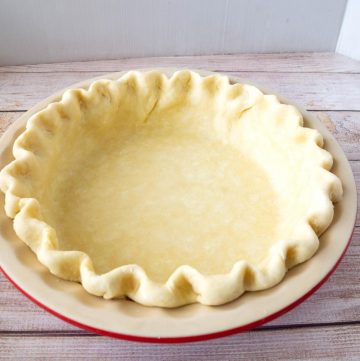 A pie pan line with pie crust.