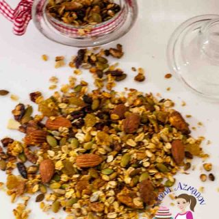 A pile of fruit and nut granola on a table.
