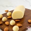 Marzipan and almonds on a wooden board