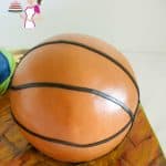 A cake decorated to look like a basketball.